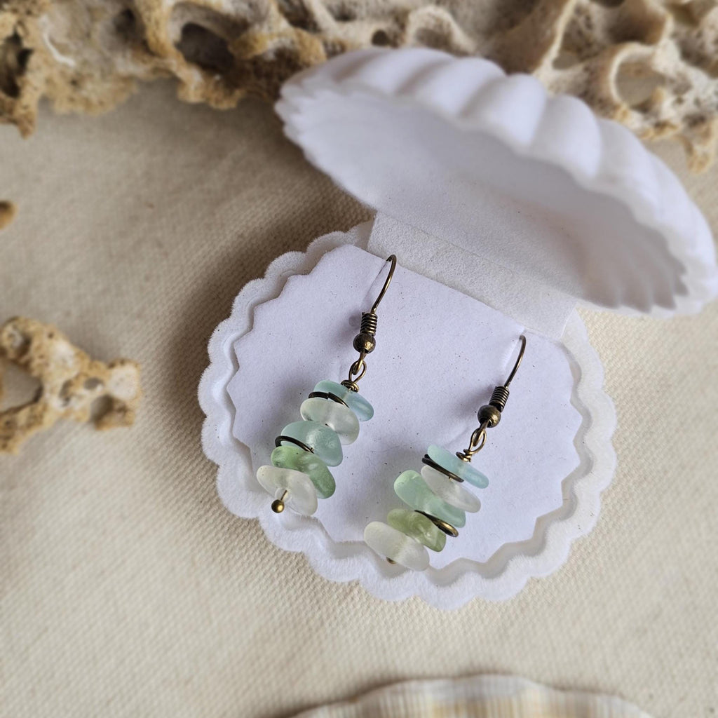 Pair of earrings with green, aqua and clear sea glass in a clam shell gift box