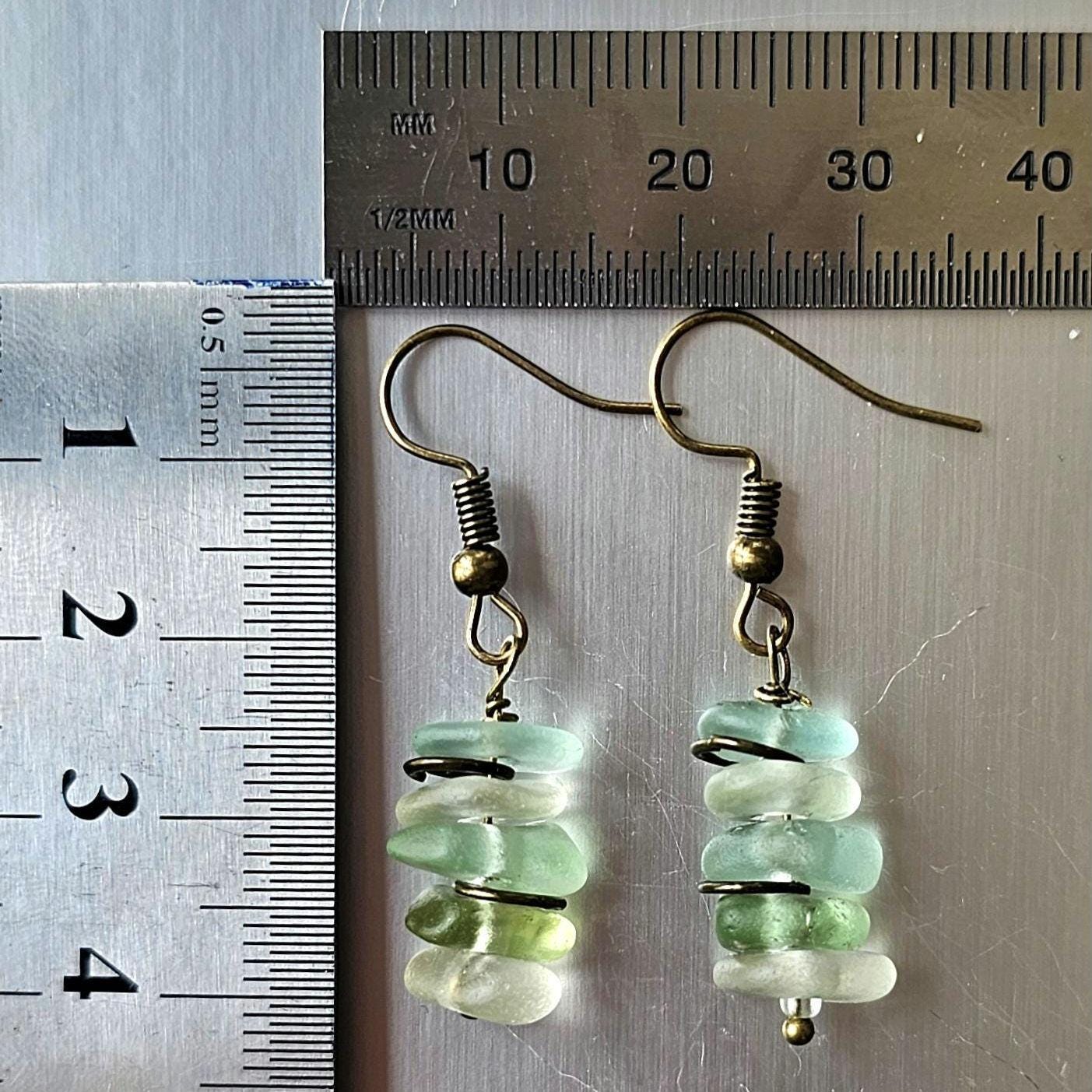 Pair of sea glass earrings with green, aqua and clear sea glass and a ruler for scale